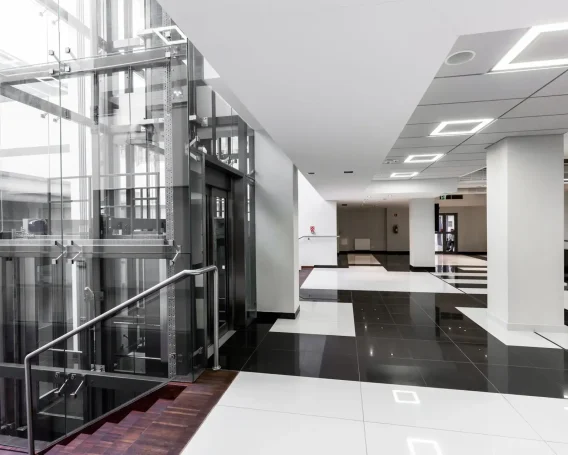modern-hallway-with-glass-elevator-2024-10-18-10-09-46-utc-scaled